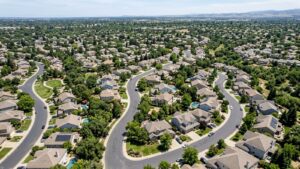 Aerial view of curving suburban streets and homes.