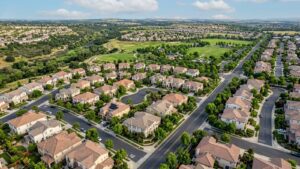 Aerial view of suburban homes and greenery.